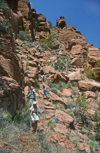 Hikers going down the route by the cliff face