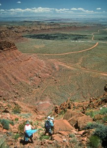 Hikers making their way down the steep drainage to the bottom of the mountain.