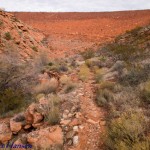 Trail becomes rocky in places and proceeds across the face of the water retention dam shown above