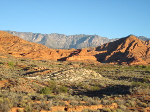 Visitors are provided with outstanding views such as this one of the distant Pine Valley Mountains and the Cottonwood Wilderness area with red sandstone formations in the foreground.